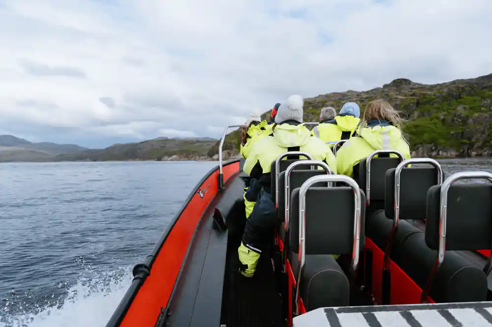 Looking forward down the RIB at seated passengers under way