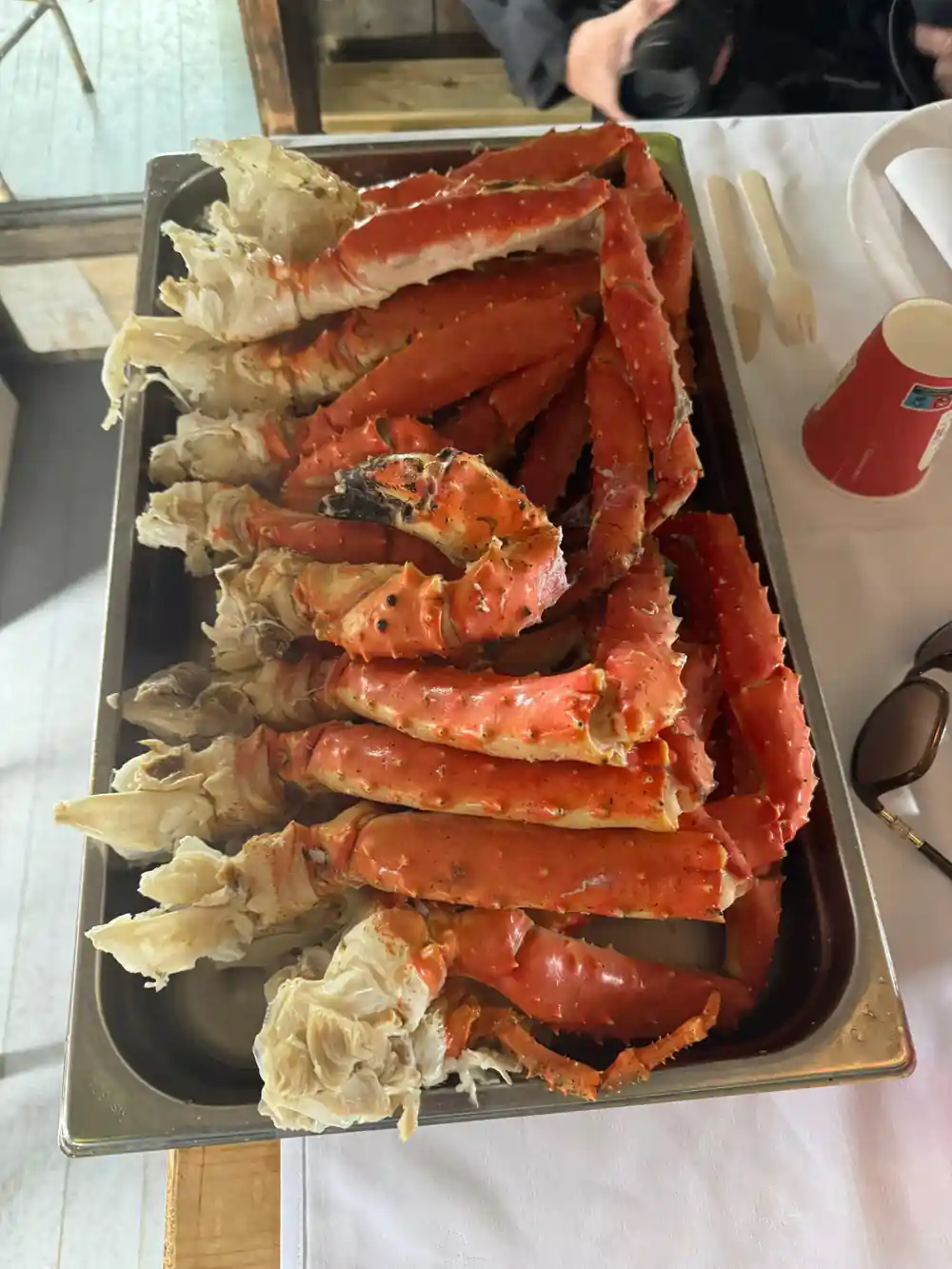 A tray of cooked crab legs on a table indoors