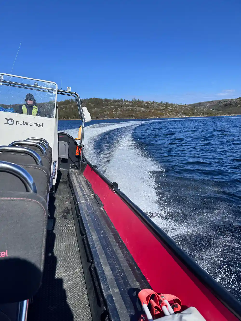 The wake behind the RIB with the fjord opening ahead